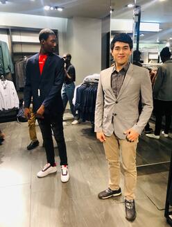 LIT youth trying on jackets in a clothing store