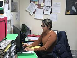 Milagros working in her office