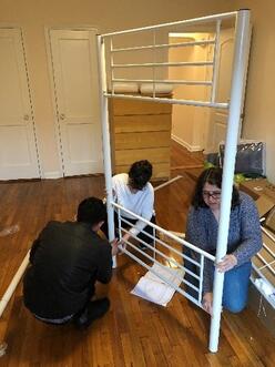 3 people building a furniture piece
