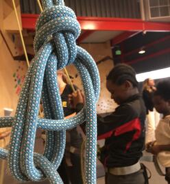 Group of girls climbing at a rock climbing gym.