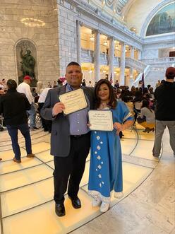 Patricia and Fabian holding journalism awards.