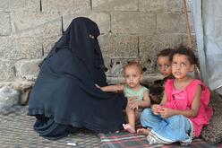 Fathiah Said Saleh Naji sits next to three of her children. 