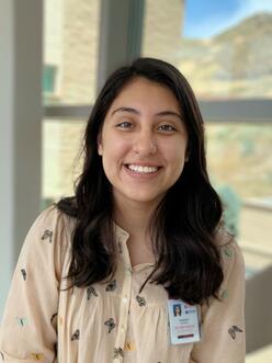 Online youth tutor, Raquel, portrait with windows in the background.