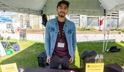 Man standing at information booth.