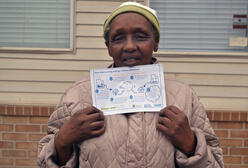 Woman holding a clean energy sign.