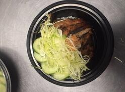 Bowl of nutritious food setting on a table.