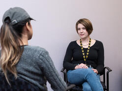 Two women facing each other and talking