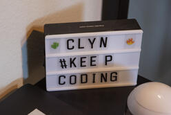 A sign that says CLYN, KEEP CODING