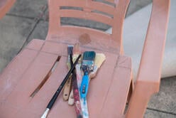 Diala Brisly's paintbrushes sit on a chair on her terrace 