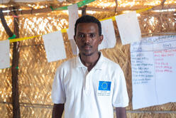 A man wearing an EU shirt poses for the camera. 