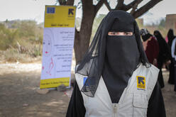 A young woman with an IRC-branded vest