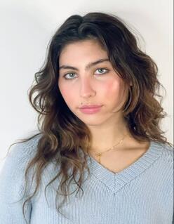 A headshot of Toni Cornell wearing a light blue sweater