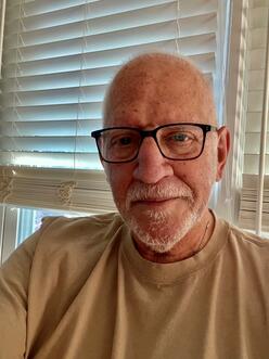 Selfie of Bob Gordon, in front of a window with shuttered blinds.