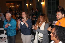 Attendees at the IRC in Denver's Welcome Home fundraiser standing and clapping.