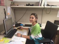 Sundos Sharaf sits at her desk at IRC in Los Angeles as IRC Los Angeles's newest caseworker