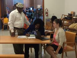 IRC intern helps participants at the IRC monthly citizenship workshop