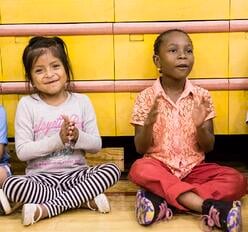 Students cheer classmates during a basketball game at the 2016 Refugee Youth Summer Academy.