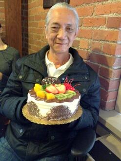 Mr Long with a cake honoring his retirement