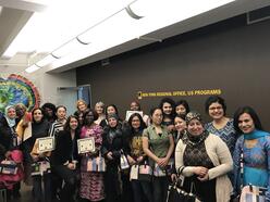 2017 POWER graduates showing their certificates at the IRC in NY lobby