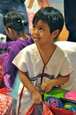 A refugee child receives gifts in Texas for the holidays