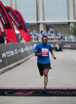 Tolassa crosses the finish line.