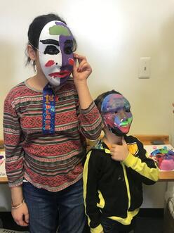 Children wear masks created during an after-school activity series.