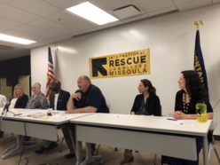 Panel of speakers seated in front of IRC logo