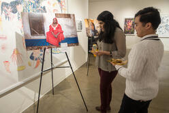 Force For Change guests viewing the photo exhibition.