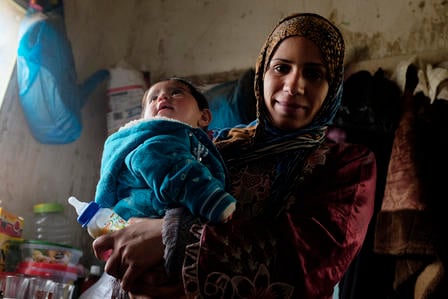A Syrian woman with her child living in Jordan