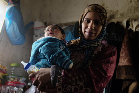 A Syrian woman in Jordan A Syrian woman with her child living in Jordan
