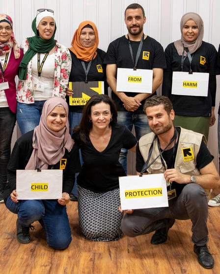 Sheryl Sandberg poses for a photo with IRC staff in Jordan in Aug. 2019
