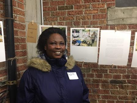 Leonia, gardener with New Roots in SLC, is grateful for the farmers market. Leonia, gardener with New Roots, standing in front of her photographs.