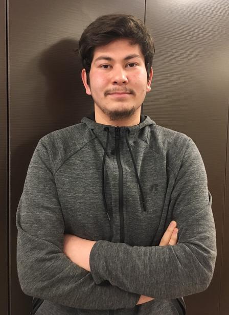 Abdul Bari, a senior at a local high school, founded and leads the robotics team. Abdul Bari standing with arms folder for a photo.