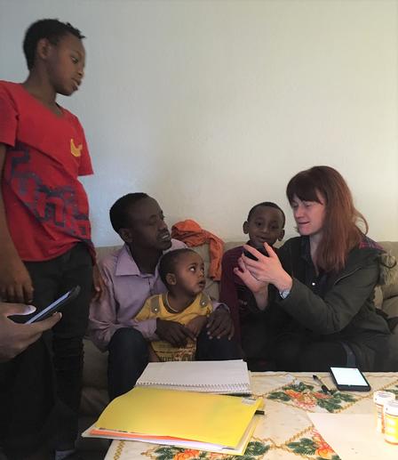 Erica uses her phone to communicate with the family she mentors. Erica, a health mentor with the International Rescue Committee in Salt Lake City, uses her phone as a translator to communicate with the family she mentors.