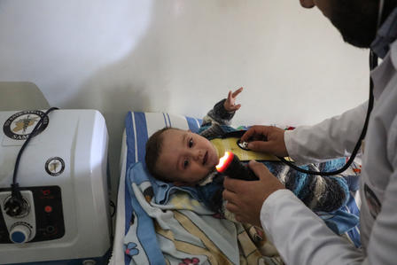 Syrian baby being treated at a children's clinic in Idlib, Syria