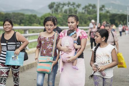 Women and children walk across the bridge between Venezuela and the city of Cucuta, Colombia. 