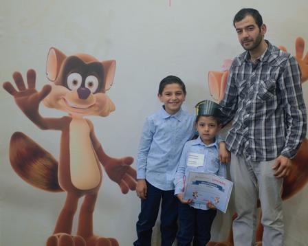 An UPSTART graduate poses with his family at the graduation ceremony at the International Rescue Committee in Salt Lake City.