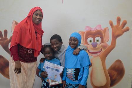 An upstart graduate poses with her family during the graduation ceremony at the International Rescue Committee in Salt Lake City.