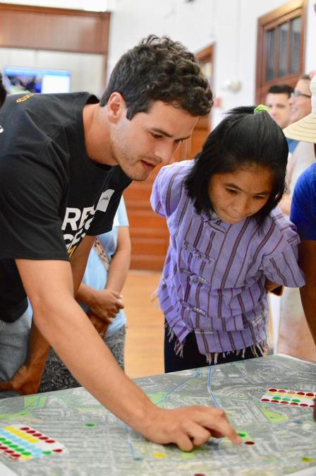 a man and a woman stand over a map of the city