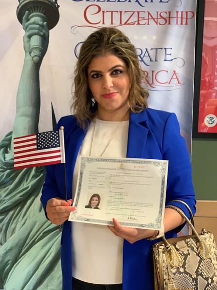 Reflecting on what it means to her to be an American, Lina shared, “I am looking forward to dreaming bigger and assisting others. I know this is just the beginning of my greatness.” Lina holding her citizenship certificate and an American flag after she was sworn in as a US citizen.