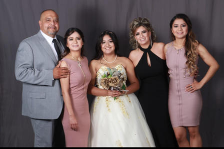 Alex poses for a photo with her twin sister, her 15-year-old sister, and their parents