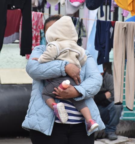 Alma, an asylum seeker from Guatemala, and her daughter wait for their laundry to dry in the outdoor living space of a shelter in Ciudad Juarez. Alma, an asylum seeker from Guatemala, and her daughter wait for their laundry to dry in the outdoor living space of a shelter in Ciudad Juarez.