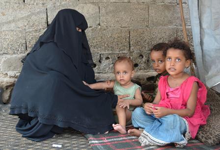 Fathiah Said Saleh Naji sits next to three of her children. 