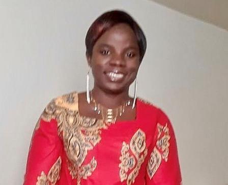 Flavia, a refugee from the DRC, is sharing her first piece of writing. Flavia, a refugee from the Democratic Republic of the Congo, posing for a photo against a white wall.