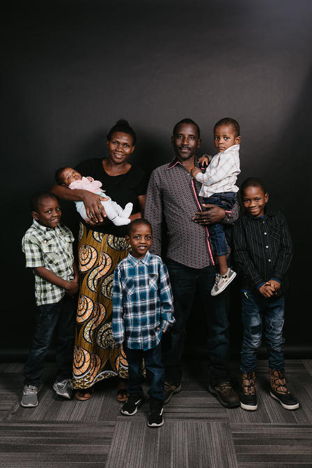Elie and his family have made their home in Utah. Family photograph of African family of seven.