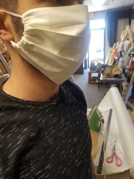 The side profile of a man modelling a white mask