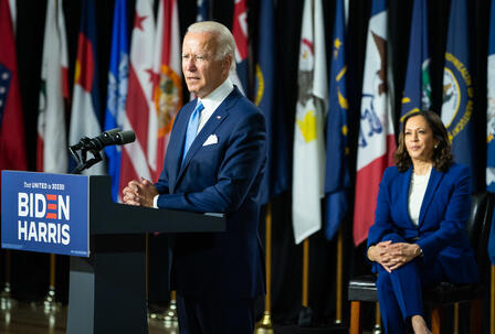 President Joe Biden and Vice President Kamala Harris President Joe Biden stands at a podium giving a speech while Vice President Kamala Harris sits on stage. The new administration takes office after four years of Trump Administration policies that wreaked havoc on the lives of refugees and asylum seekers.