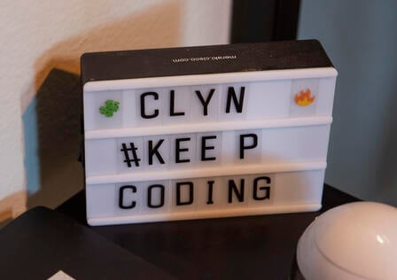 A sign that says CLYN, KEEP CODING