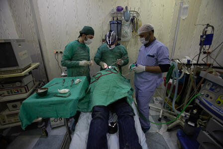 A surgical team in a Syrian operating room with a patient