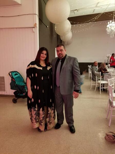 Ali and Ahed, participants of Spice Kitchen Incubator, stand together at an event in formal clothes. 